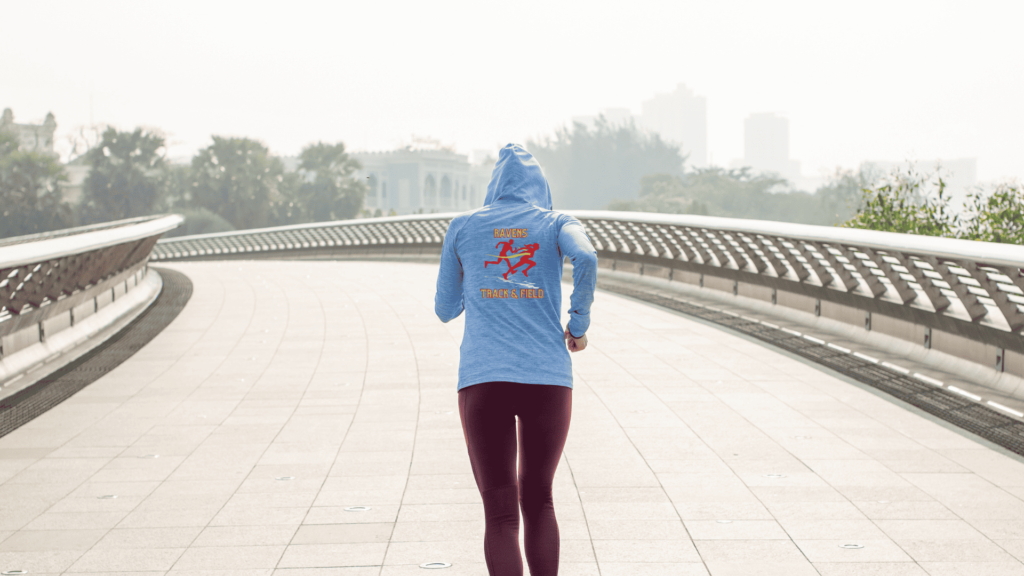 Girl running with her back to the camera to show off her custom track hoodie